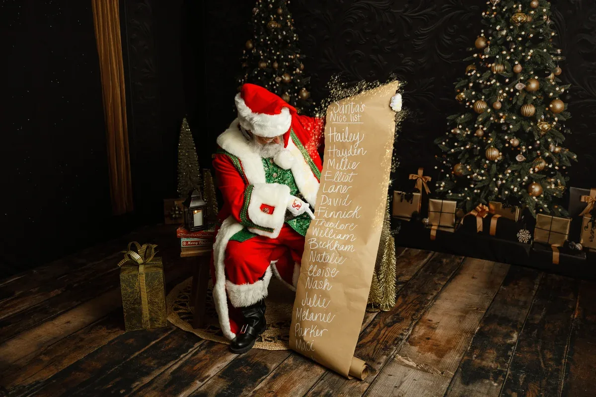 Santa Michael carefully checking his long Christmas list.