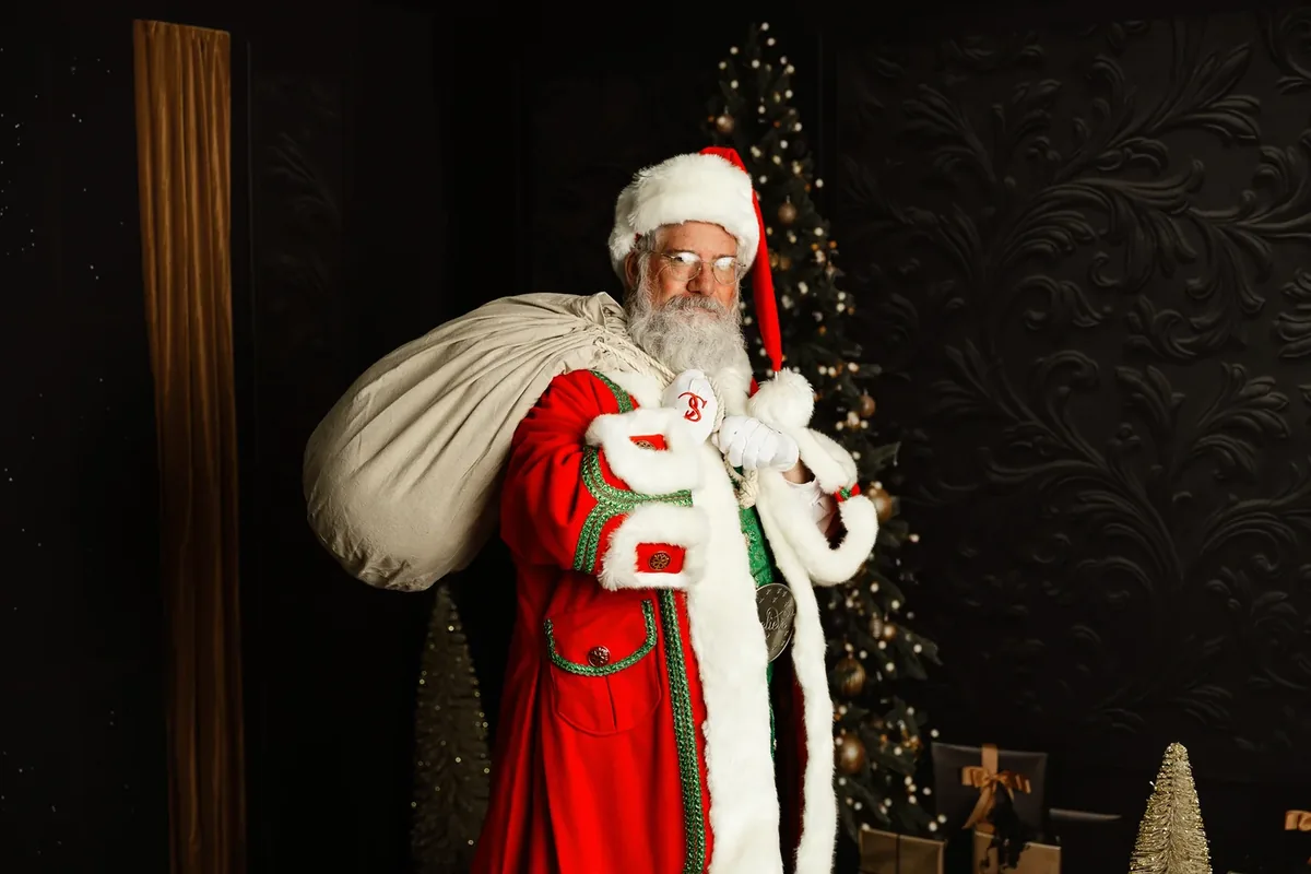 Santa Michael carrying his Christmas gift sack.