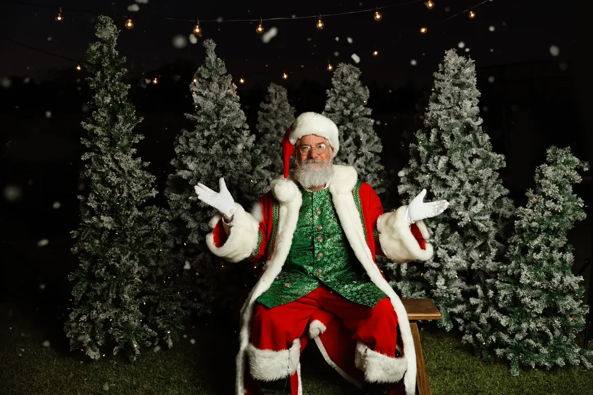 Santa Michael welcoming Christmas wishes among decorated trees.